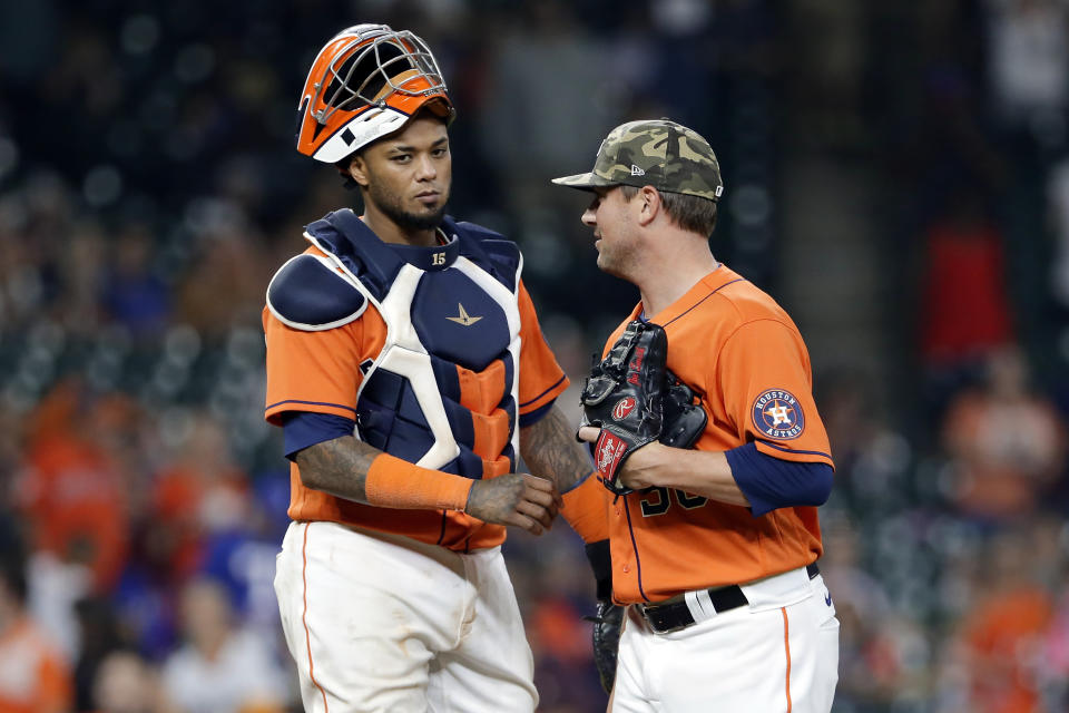 Houston Astros catcher Martin Maldonado, left, and closing pitcher Joe Smith congratulate each other after their win over the Texas Rangers after a baseball game Friday, May 14, 2021, in Houston. (AP Photo/Michael Wyke)