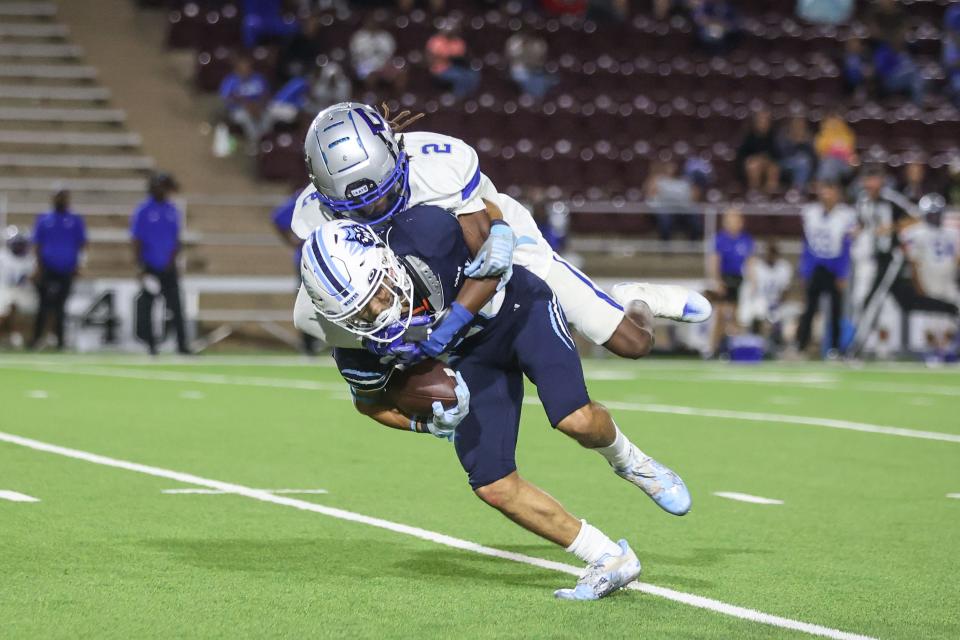 West Plains' Trae Ferril (18) is tackled by Estacado's Ja'myzon Taylor (2), Thursday, Sept. 22, 2022, at Happy State Bank Stadium in Canyon. West Plains won, 35-14.