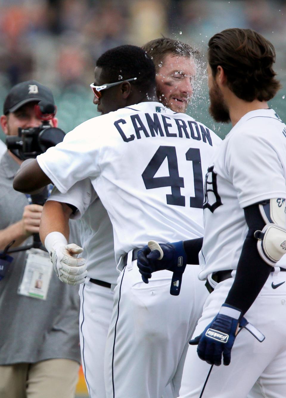 Detroit Tigers' Robbie Grossman receives a hug from Daz Cameron (41) after laying a sacrifice bunt to score Akil Baddoo and defeat the Houston Astros in the 10th inning of a baseball game Sunday, June 27, 2021, in Detroit.