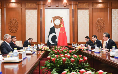 Pakistan’s Foreign Minister Khawaja Muhammad Asif (left) and Chinese State Councilor and Foreign Minister Wang Yi (right) have a meeting at the Diaoyutai State Guest House in Beijing, China, April 23, 2018. Madoka Ikegami/Pool via Reuters