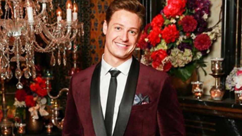 The Bachelor Australia Matt Agnew wearing a maroon velvet jacket.