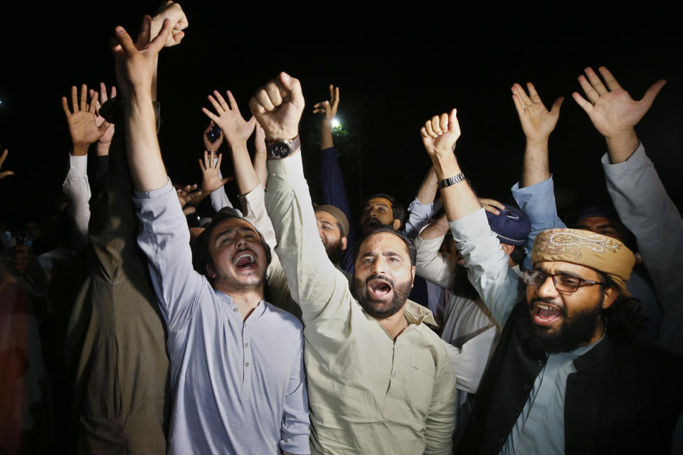 Supporters of an opposition party chant slogans as they celebrate the success of a no-confidence vote against Prime Minister Imran Khan outside the National Assembly, in Islamabad, Pakistan, Sunday, April 10, 2022. Pakistan's political opposition ousted the country's embattled prime minister in a no confidence vote on Saturday, which they won after several of Imran Khan's allies and a key coalition party deserted him. (AP Photo/Anjum Naveed)