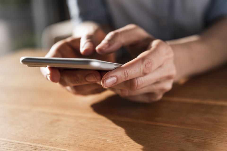 hands holding a cell phone