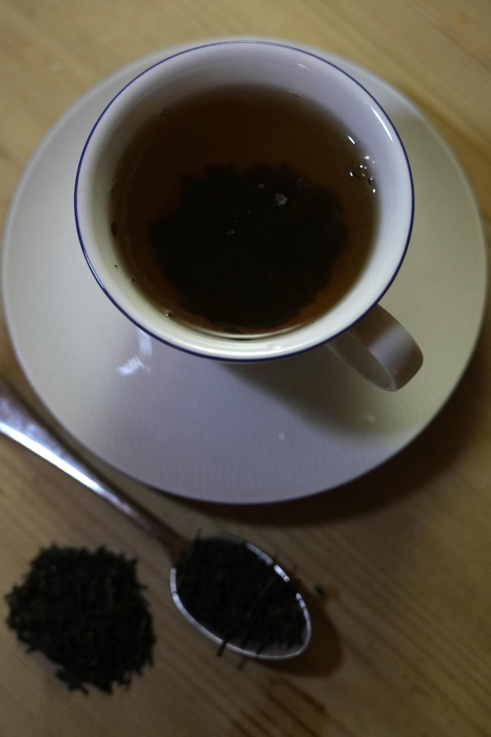 A cup of black tea with spoon and tea leaves is pictured in London, Monday, Aug. 29, 2022. Tea can be part of a healthy diet and tea drinkers may even be a little more likely to live longer than those who don't, according to a large study of British tea drinkers. Tea contains helpful substances known to reduce inflammation. Past studies in China and Japan, where green tea is popular, suggested health benefits. The new study extends the good news to the U.K.’s favorite drink: black tea. The study, published Monday, Aug. 29, 2022 in Annals of Internal Medicine, found the association held up for heart disease deaths, but there was no clear trend for cancer deaths. (AP Photo/Alastair Grant)