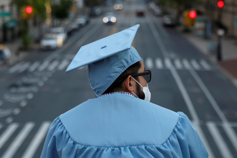 A graduating Masters student from the Columbia University Graduate School of Architecture, Planning and Preservation (GSAPP) stands on campus the day before his graduation ceremony, which is to be held online due to the outbreak of the coronavirus disease (COVID-19) in Manhattan, New York City, U.S., May 15, 2020. REUTERS/Andrew Kelly     TPX IMAGES OF THE DAY