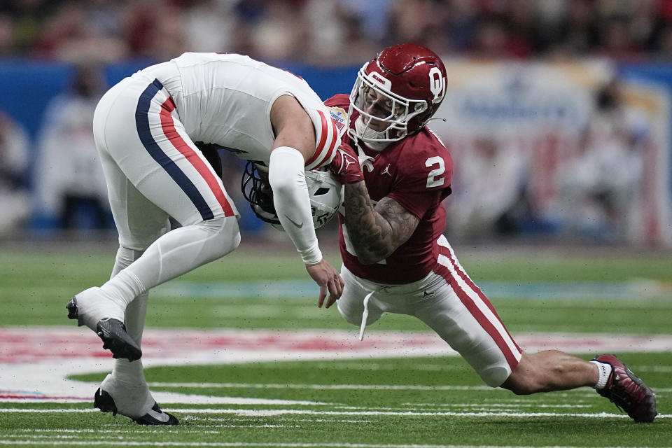 Arizona quarterback Noah Fifita (11) is stopped by Oklahoma defensive back Billy Bowman Jr. (2) during the first half of the Alamo Bowl NCAA college football game in San Antonio, Thursday, Dec. 28, 2023. (AP Photo/Eric Gay)