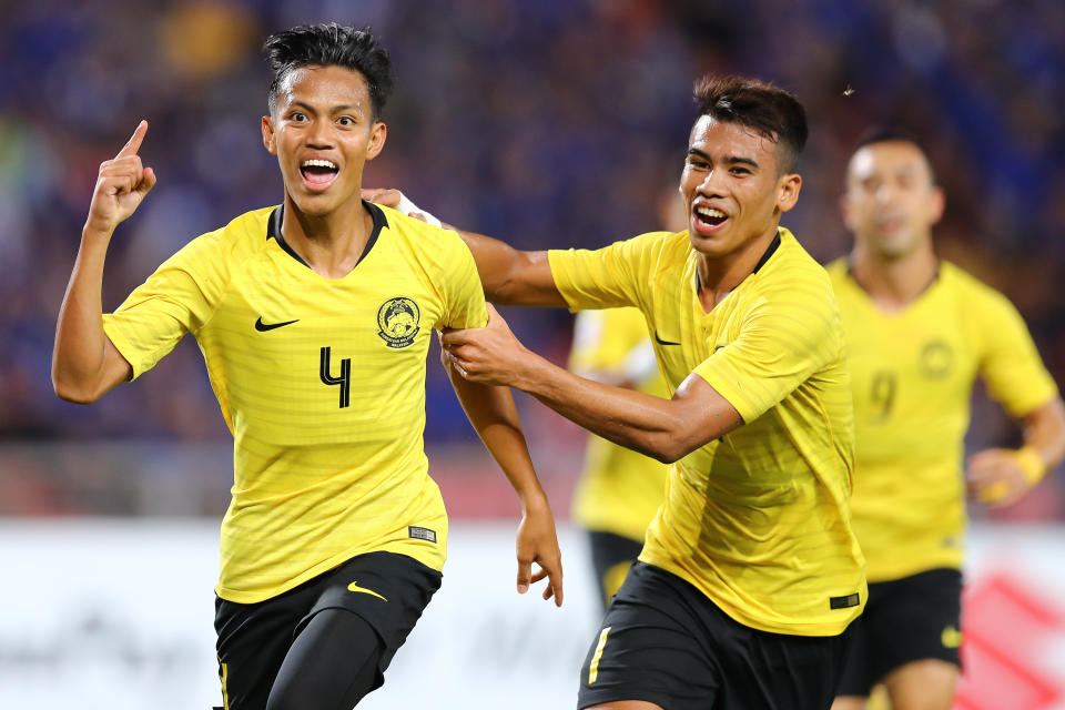 Malaysia's Syahmi Safari (left) celebrates scoring at the 2018 AFF Suzuki Cup semi-final second leg match against Thailand.