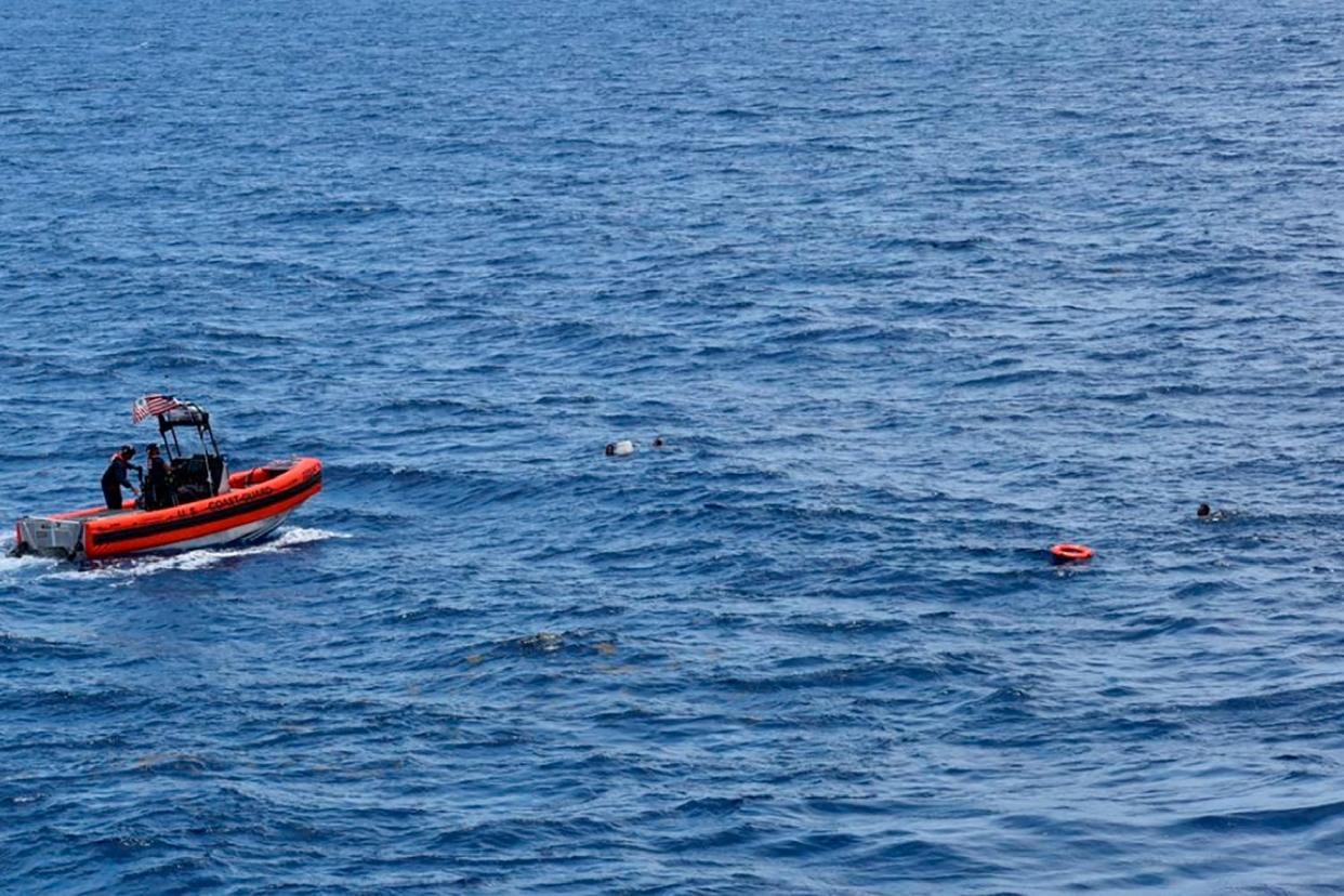 <p>A Coast Guard crew rescues eight people from the water approximately 16 miles south of Key West</p> (US Coast Guard)