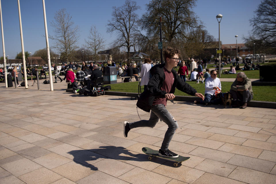 People enjoy a fine spring day in Stratford-upon-Avon, England, Sunday April 4, 2021. During current coronavirus restrictions people are allowed to meet up and exercise in the open air. (Jacob King/PA via AP)