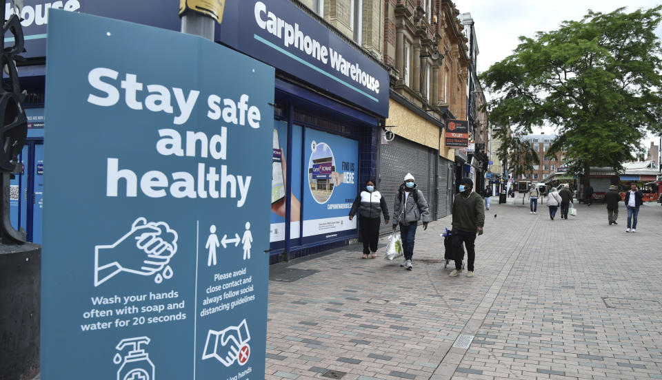 People walk in Leicester city centre, England, Tuesday June 30, 2020. The British government has reimposed lockdown restrictions in the English city of Leicester after a spike in coronavirus infections, including the closure of shops that don't sell essential goods and schools. (AP Photo/Rui Vieira)