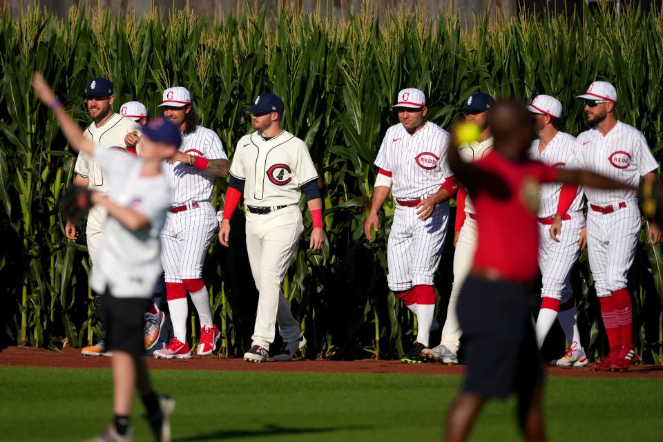 Cincinnati Reds second baseman Jonathan India (6), Chicago Cubs left fielder Ian Happ (8), Cincinnati Reds first baseman Joey Votto (19), Cincinnati Reds shortstop Kyle Farmer (17) and Cincinnati Reds right fielder Albert Almora Jr. (3) enter right field from the corn fields prior to a game against the Chicago Cubs, Thursday, Aug. 11, 2022, at the MLB Field of Dreams stadium in Dyersville, Iowa. 