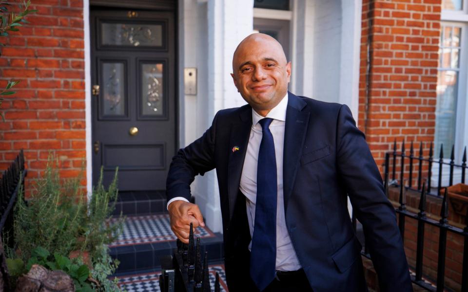 Sajid Javid was all smiles outside his family home this evening - Jamie Lorriman