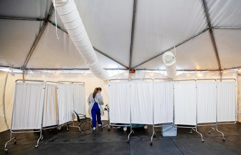 A triage tent to examine potential COVID-19 patients is set up outside Lee Memorial Hospital in Fort Myers, Fla. The tents help prevent the virus from spreading into the emergency room and main hospital.