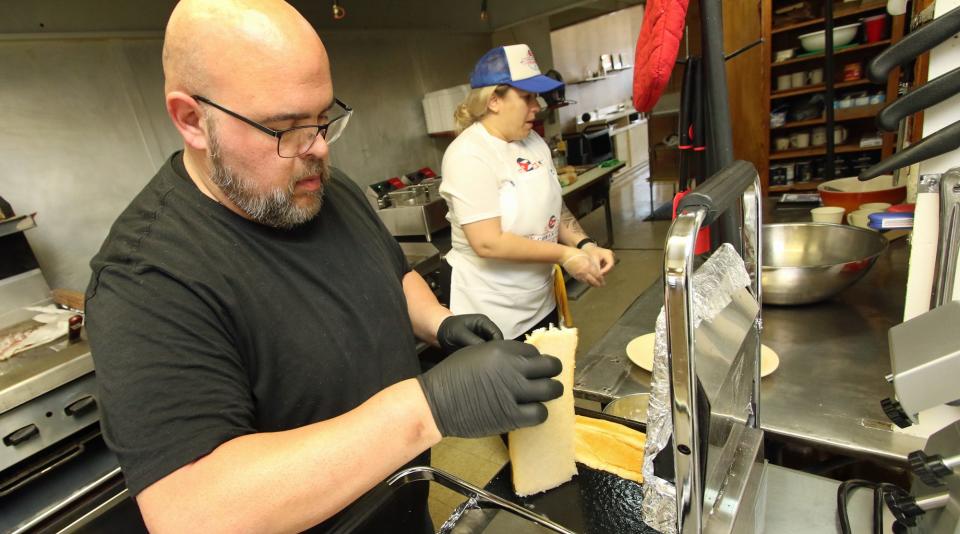 Manny Gonzalez works on a breakfast order in the kitchen of the newly opened My Cuban Corner on Catawba Street in Belmont Monday morning, March 6, 2023.