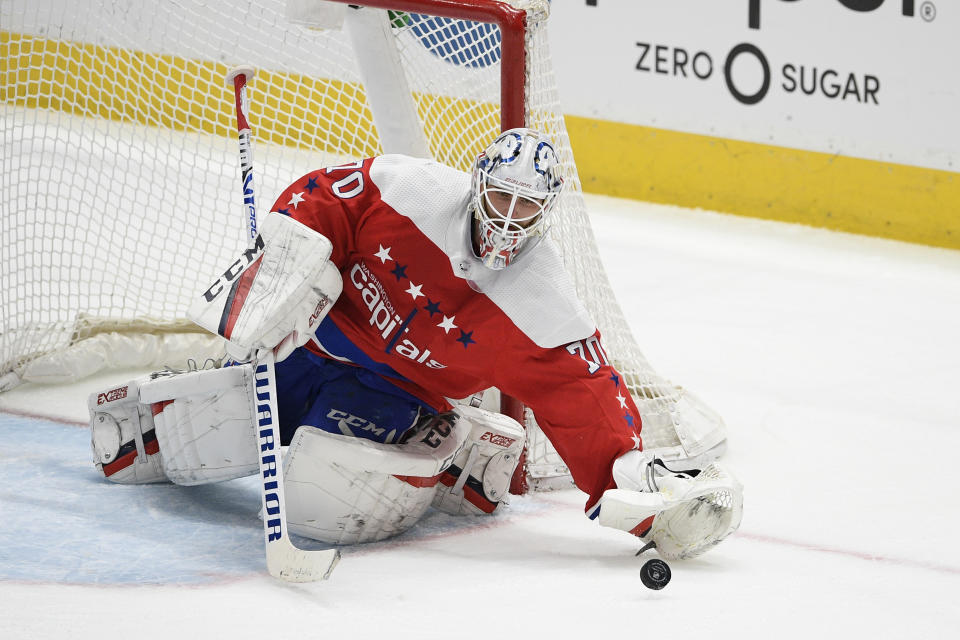 FILE - In this Feb. 23, 2020, file photo, Washington Capitals goaltender Braden Holtby (70) reaches for the puck during the third period of an NHL hockey game against the Pittsburgh Penguins in Washington. The Vancouver Canucks signed Holtby to an $8.6 million, two-year deal after letting Jacob Markstrom leave in free agency. (AP Photo/Nick Wass, File)