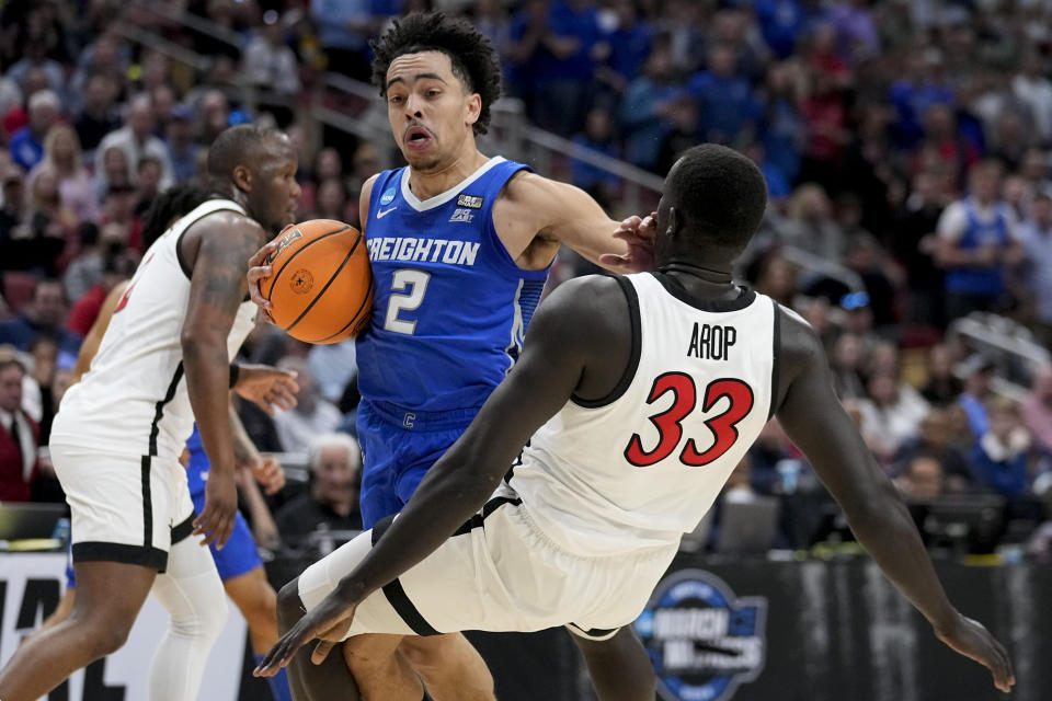 Creighton guard Ryan Nembhard (2) runs into San Diego State forward Aguek Arop (33) in the first half of a Elite 8 college basketball game in the South Regional of the NCAA Tournament, Sunday, March 26, 2023, in Louisville, Ky. (AP Photo/John Bazemore)