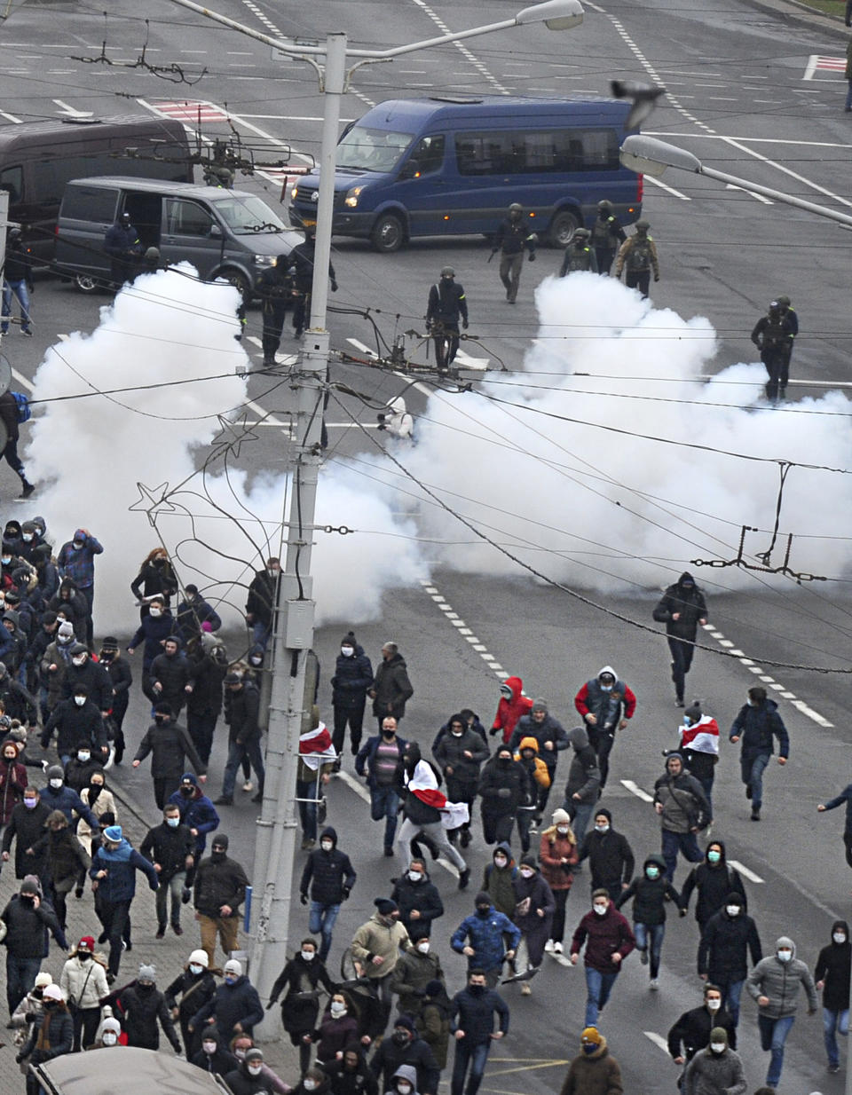 Belarusian riot police use flash grenades against demonstrators during an opposition rally to protest the official presidential election results in Minsk, Belarus, Sunday, Nov. 15, 2020. The Sunday demonstrations continued to wave of near-daily protests that have gripped Belarus since early August. In the capital Minsk, police wielded clubs and used tear gas and water cannon disperse thousands of demonstrators. (AP Photo)