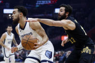 Memphis Grizzlies guard Tyus Jones drives against Cleveland Cavaliers guard Ricky Rubio (13) during the first half of an NBA basketball game, Thursday, Feb. 2, 2023, in Cleveland. (AP Photo/Ron Schwane)