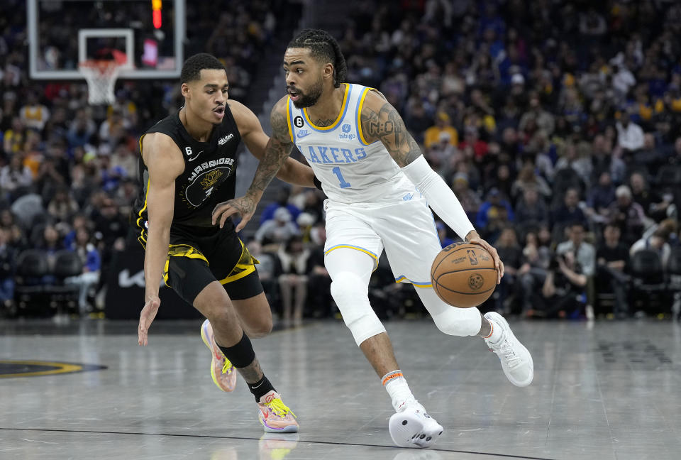 SAN FRANCISCO, CALIFORNIA - FEBRUARY 11: D'Angelo Russell #0 of the Los Angeles Lakers dribbles past Jordan Poole #3 of the Golden State Warriors during the third quarter at Chase Center on February 11, 2023 in San Francisco, California. NOTE TO USER: User expressly acknowledges and agrees that, by downloading and or using this photograph, User is consenting to the terms and conditions of the Getty Images License Agreement. (Photo by Thearon W. Henderson/Getty Images)