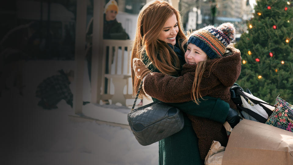 Isla Fisher as Mackenzie and Willa Skye as Mia in GODMOTHERED, exclusively on Disney+. 