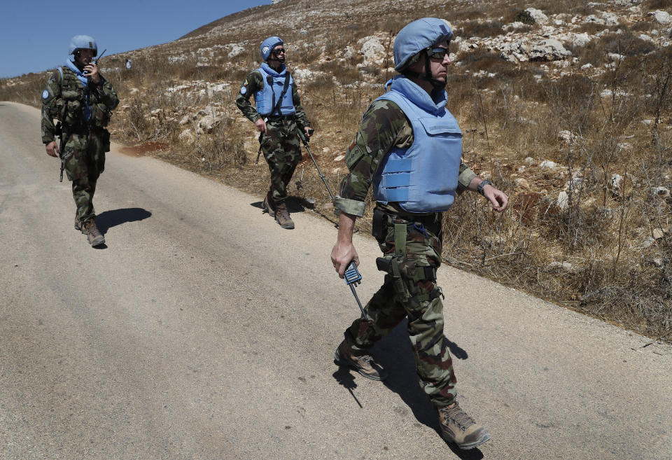 Irish UN peacekeepers patrol near the fields struck by Israeli army shells in the southern Lebanese-Israeli border village of Maroun el-Ras, Lebanon, Monday, Sept. 2, 2019. The Lebanon-Israel border was mostly calm with U.N. peacekeepers patrolling the border Monday, a day after the Lebanese militant Hezbollah group fired a barrage of anti-tank missiles into Israel, triggering Israeli artillery fire that lasted less than two hours and caused some fires. (AP Photo/Hussein Malla)