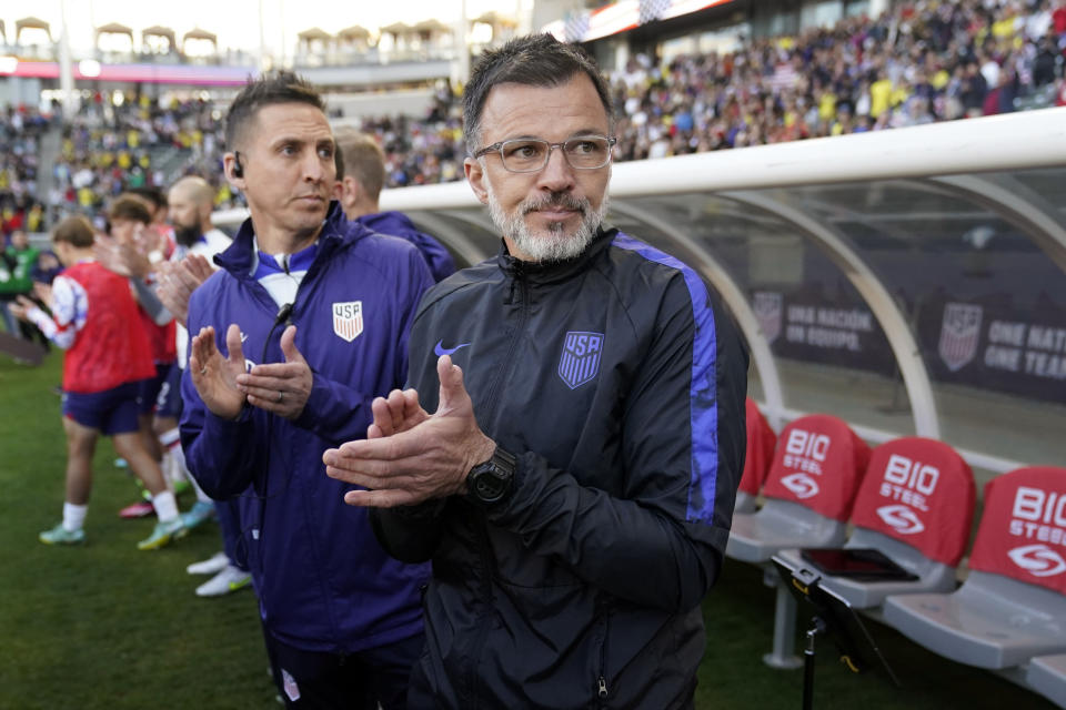 U.S. coach Anthony Hudson, front, claps in the bench area before the team's international friendly soccer match against Colombia on Saturday, Jan. 28, 2023, in Carson, Calif. (AP Photo/Marcio Jose Sanchez)