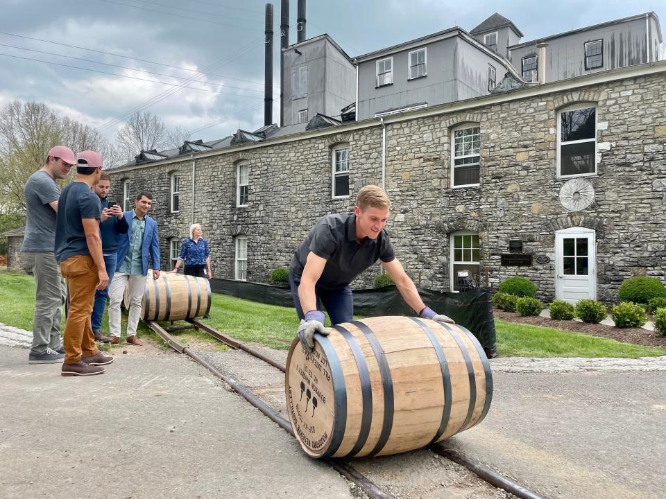 Owners of Derby horse Hot Rod Charlie roll bourbon barrels at Woodford Reserve Distillery.