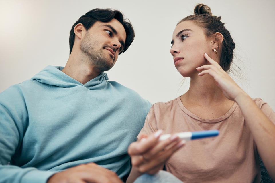 A couple looking at a pregnancy test