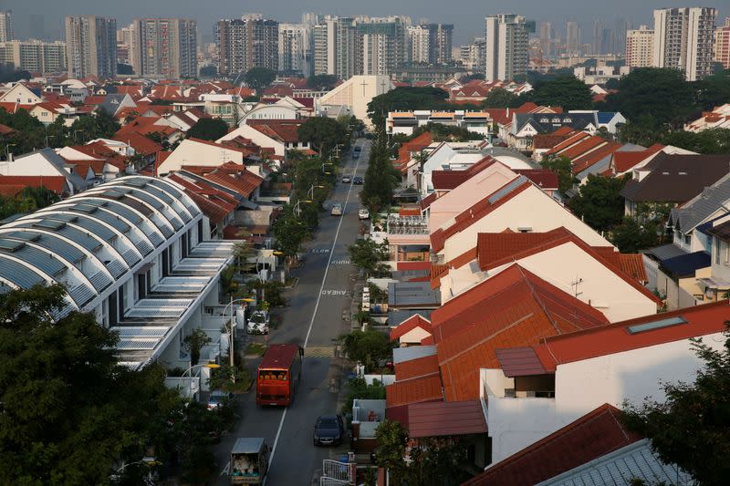 FILE PHOTO: Vehicles pass private landed residential properties at a neighbourhood in Singapore