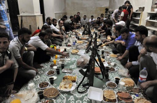 Syrian rebels break their fast with the "iftar" meal during the Muslim fasting month of Ramadan in the northern city of Aleppo. A commercial hub and home to 2.5 million people, Syria's second city Aleppo has become a new front in the country's 16-month uprising, after being largely excluded from the violence