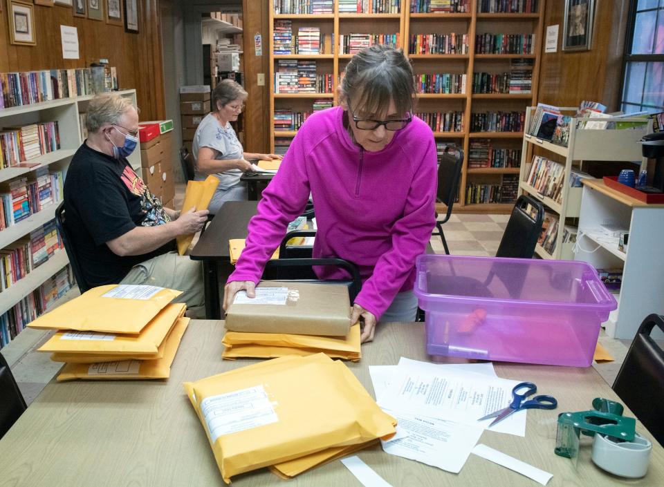 Volunteers package and label books for shipment to various prisons throughout the state at the Open Books bookstore on Guillemard Street on Wednesday, May 3, 2023. The small downtown bookstore sends prison inmates books in the hope of helping the prisoners adjust back to civilian life.