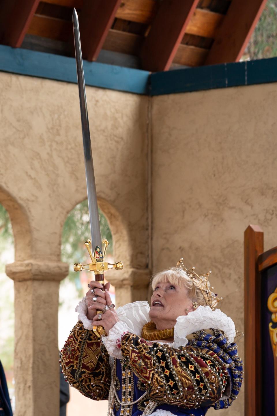 Queen of the Festival, Beckah Rubinstein holds a sword to ceremoniously knight a group of kids at the Renaissance Festival on Feb. 24, 2024 in Gold Canyon, AZ.