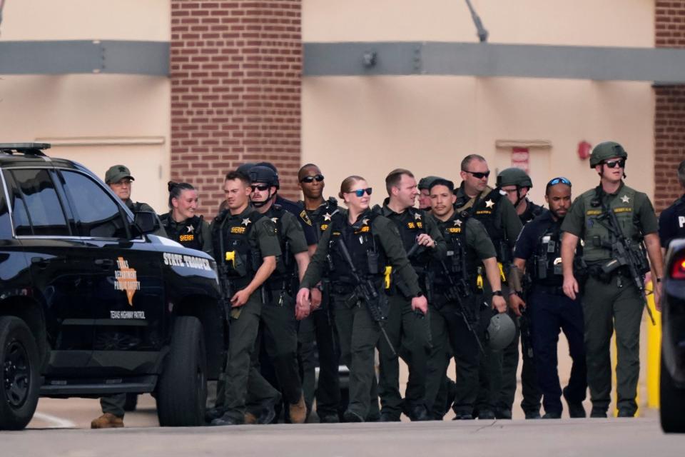 Law enforcement officers converge at a shopping center after a shooting on May 6, 2023, in Allen, Texas.