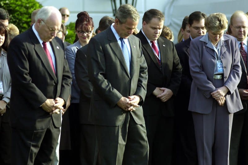 President George W. Bush leads his staff in a moment of silence on the south lawn of the White House in Washington, D.C., on September 18, 2001, with Vice President Richard Cheney to his left and advisor Karen Hughes to his right. File Photo by Michael Kleinfeld/UPI