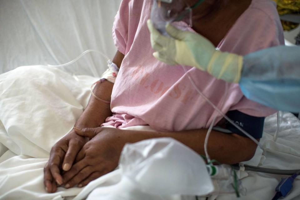 While Haiti has some beds and equipment to treat COVID-19, the population’s skepticism about whether the contagion even exists has led to a quickly mounting death toll. Here a nurse assists a COVID-19 patient at the Doctors Without Borders Drouillard Hospital in Cite Soleil, Haiti, on June 3, 2020.