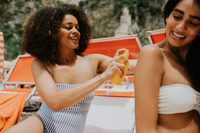 Woman applying suncream