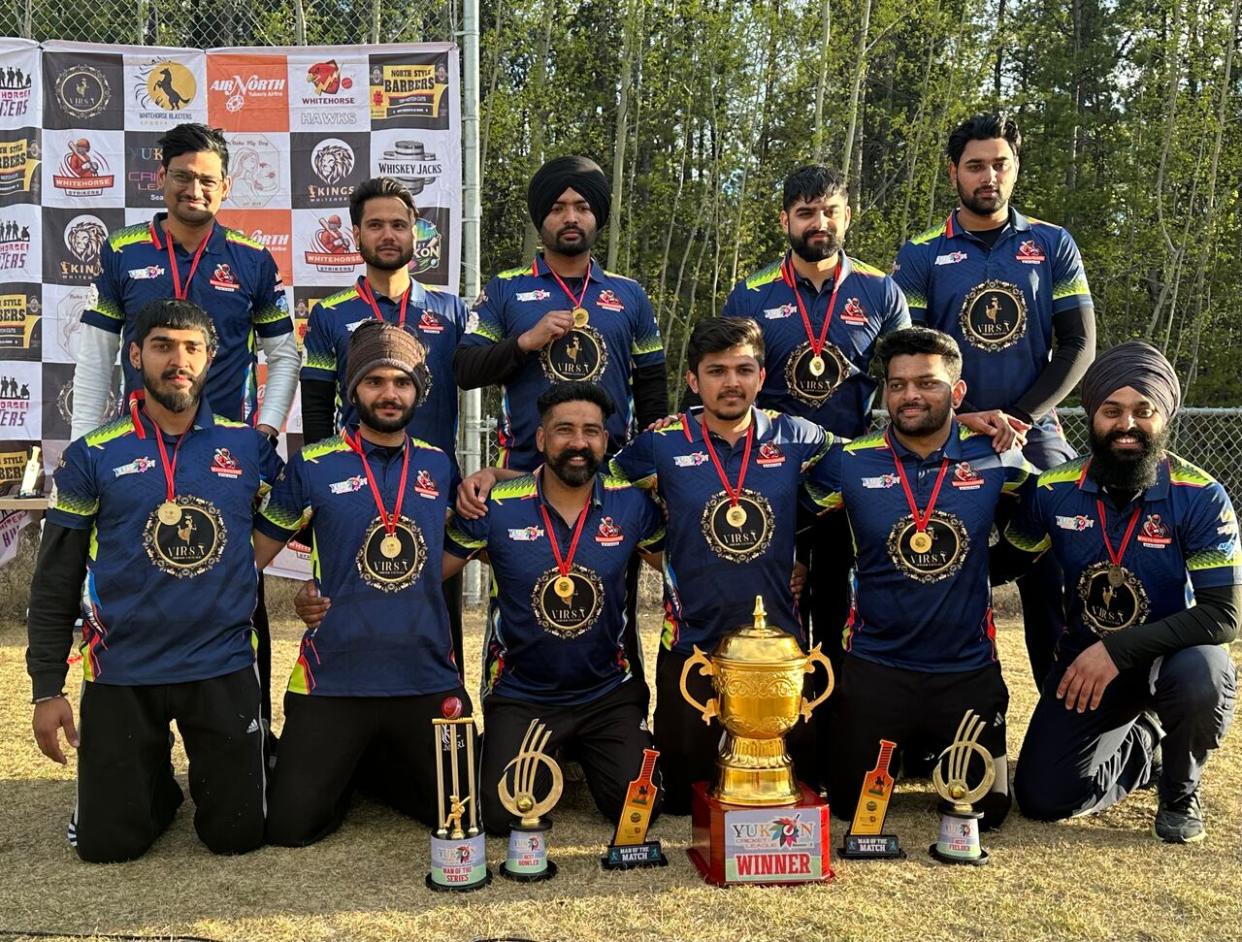 The Whitehorse Strikers pose with their trophy after winning the Yukon Cricket Association's 2nd annual tournament this past weekend. (Caitrin Pilkington/CBC - image credit)