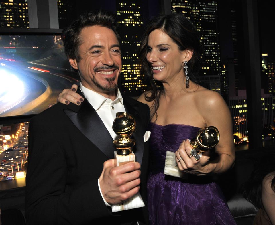 Robert Downey Jr. won for best actor in a motion picture — musical or comedy and celebrated with Sandra Bullock, who won that year for her role in <em>The Blind Side</em>. 