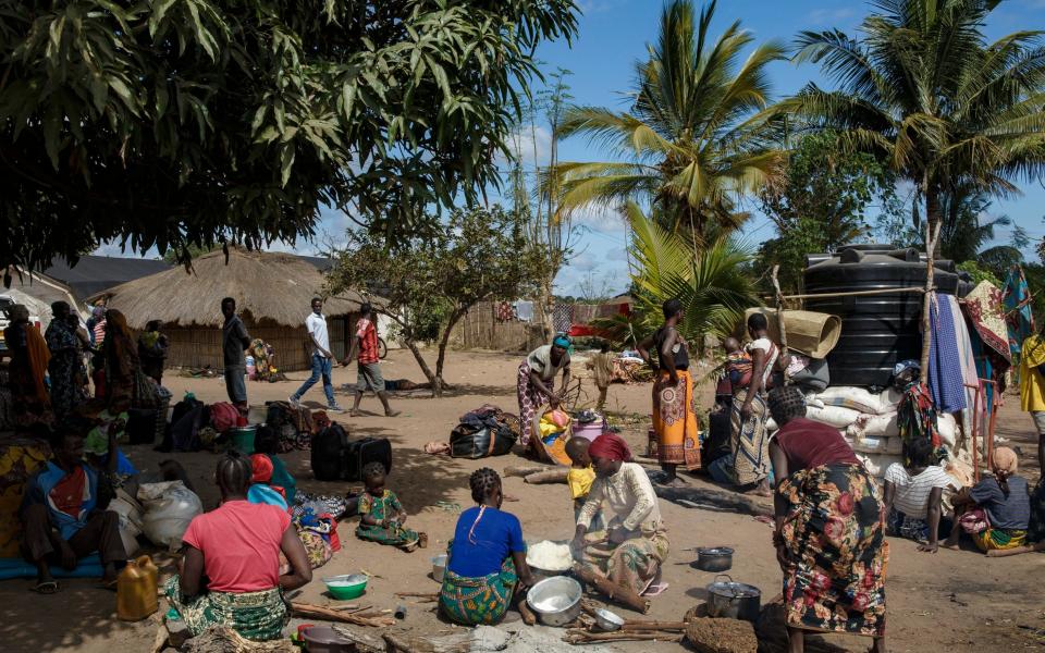 People displaced by conflict wait at a full resettlement area near Montepuez, Cabo Delgado. - Ed Ram