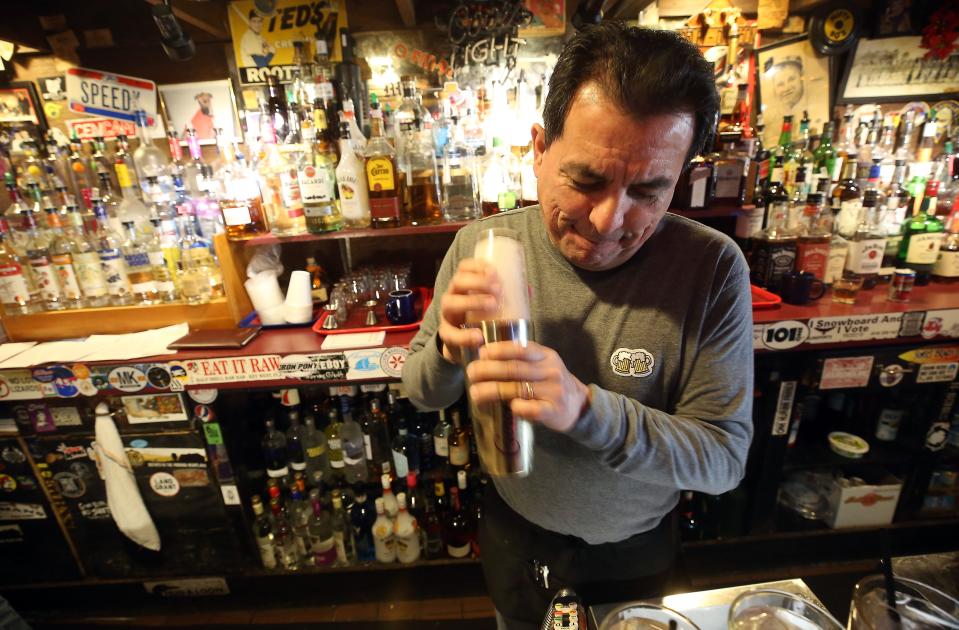 Victor Esquivel makes his signature drink, "Sex with Victor." at the Thurman Cafe on Dec. 20. Esquivel has been at Thurman for 33 years.