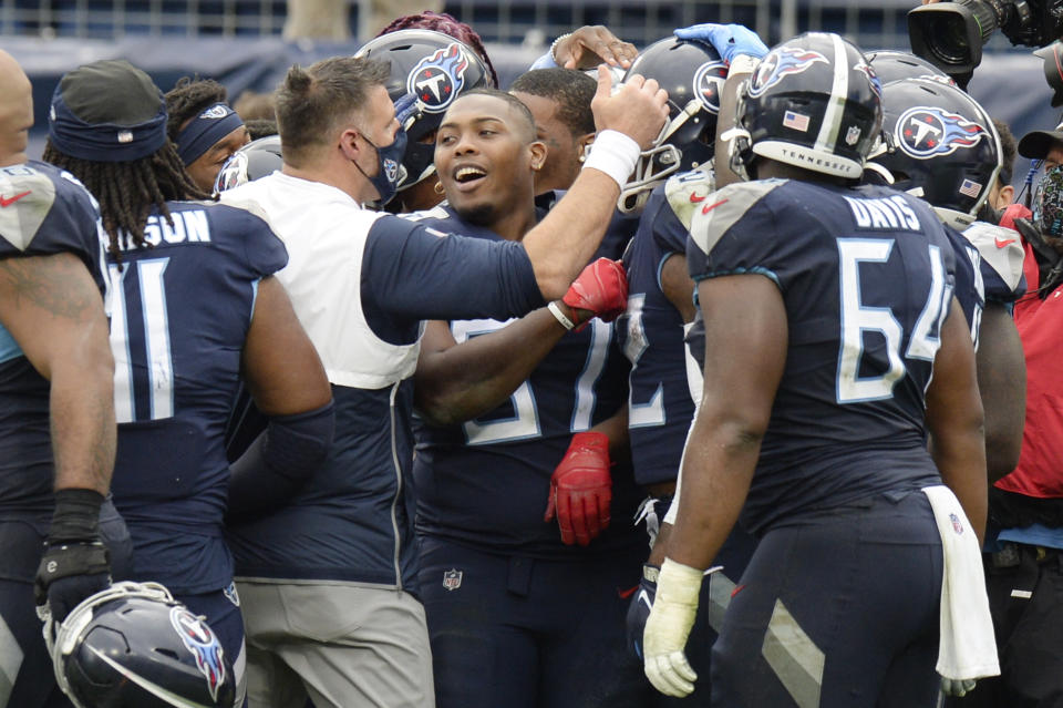Tennessee Titans head coach Mike Vrabel celebrates with his players after beating the Houston Texans in overtime of an NFL football game Sunday, Oct. 18, 2020, in Nashville, Tenn. The Titans won 42-36. (AP Photo/Mark Zaleski)