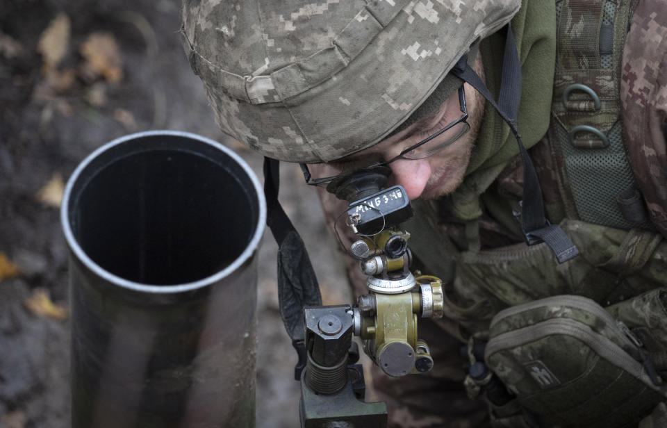 A Ukrainian soldier targets his mortar in the front line position near Bakhmut, the site of the heaviest battle against the Russian troops in the Donetsk region, Ukraine, Thursday, Oct. 27, 2022. (AP Photo/Efrem Lukatsky)