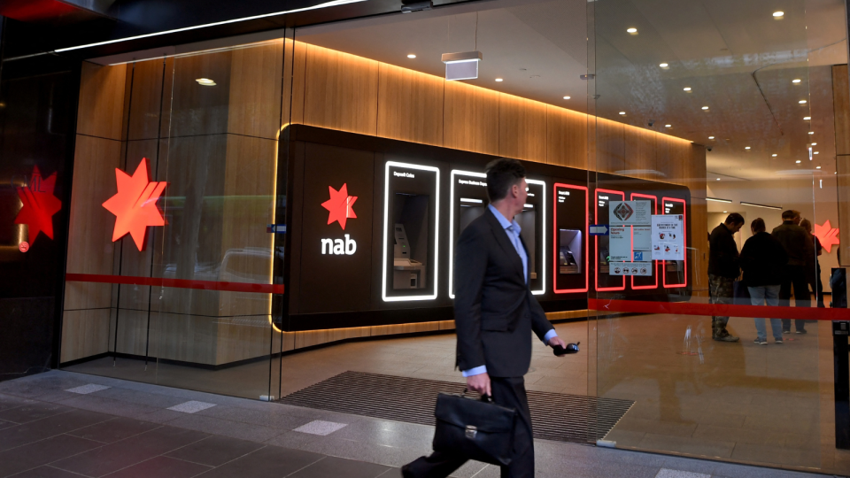 People walking in front of the NAB branch.