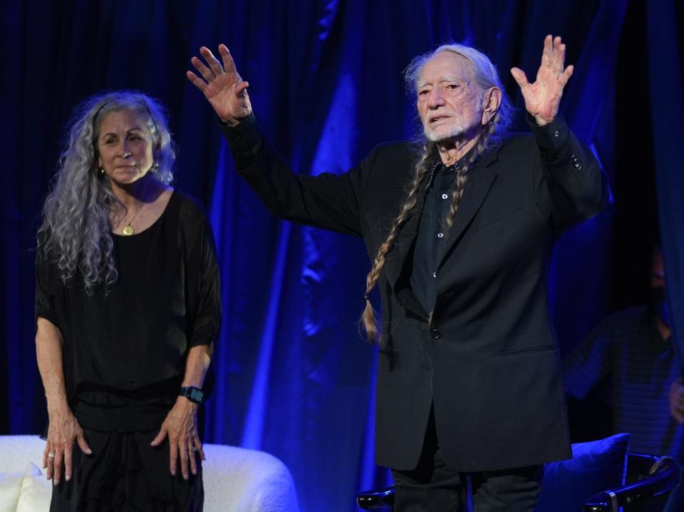 Willie Nelson receives the LBJ Liberty and Justice For All Award at a gala and musical tribute at the LBJ Presidential Library. At left is his wife, Annie D’Angelo.