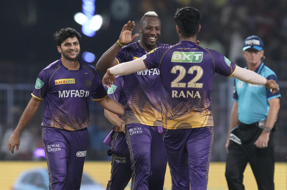 Kolkata Knight Riders' Andre Russell, center, celebrates with teammates after the run-out of Rajasthan Royals' Jos Buttler during the Indian Premier League cricket match between Kolkata Knight Riders and Rajasthan Royals in Kolkata, India, Thursday, May 11, 2023. (AP Photo/Bikas Das)