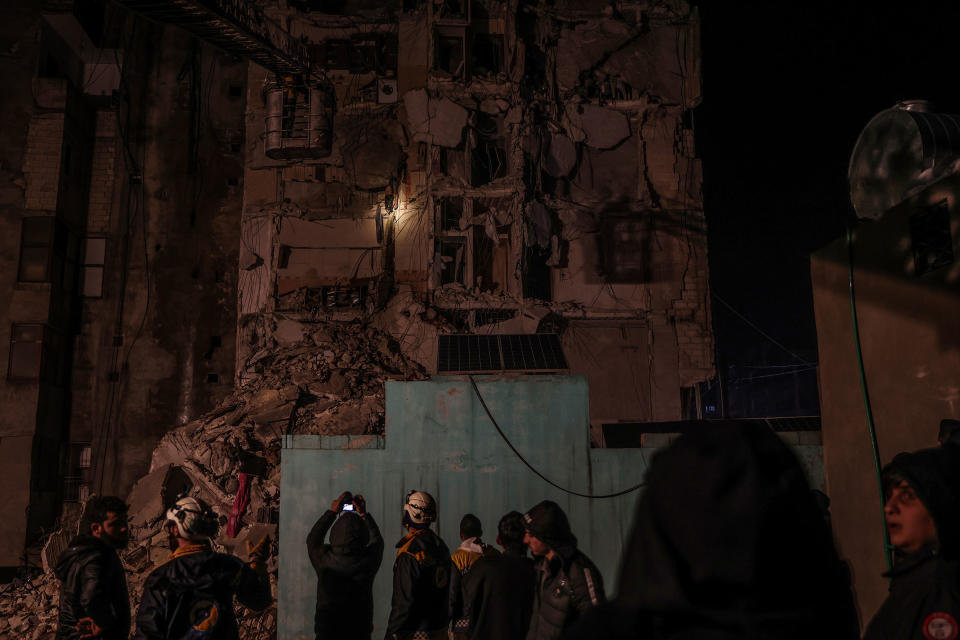 Syrian civilians and members of the White Helmets work to save people trapped beneath a destroyed building following a magnitude 7.8 earthquake that hit Syria, on Feb. 6 2023.<span class="copyright">Anas Alkharboutli—picture-alliance/dpa/AP</span>