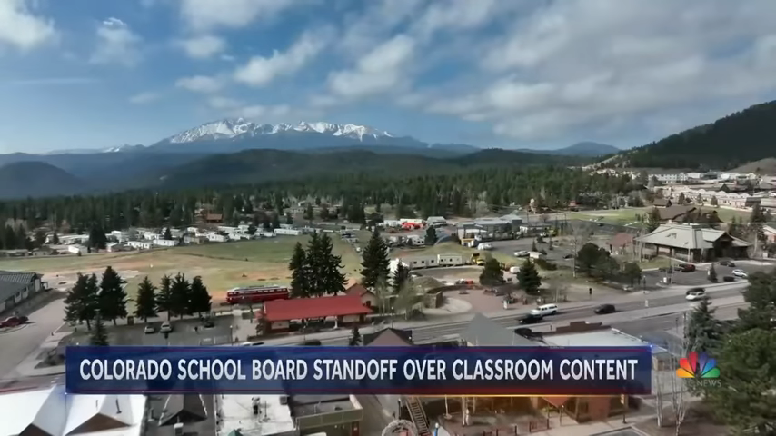 Aerial view of a town with the caption "Colorado School Board Standoff Over Classroom Content"