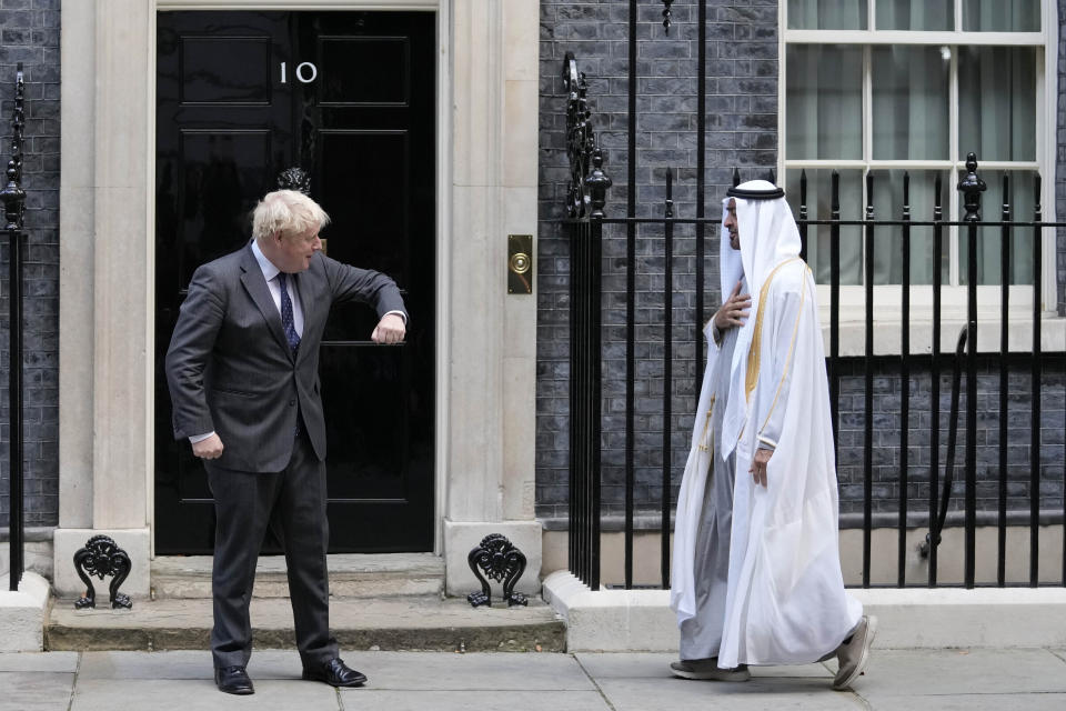 FILE - Britain's Prime Minister Boris Johnson welcomes Crown Prince of the Emirate of Abu Dhabi, Sheikh Mohammed bin Zayed Al Nahyan, to 10 Downing Street in London, Thursday, Sept. 16, 2021. The moving vans have already started arriving in Downing Street, as Britain's Conservative Party prepares to evict Johnson. Debate about what mark he will leave on his party, his country and the world will linger long after he departs in September. (AP Photo/Frank Augstein, File)