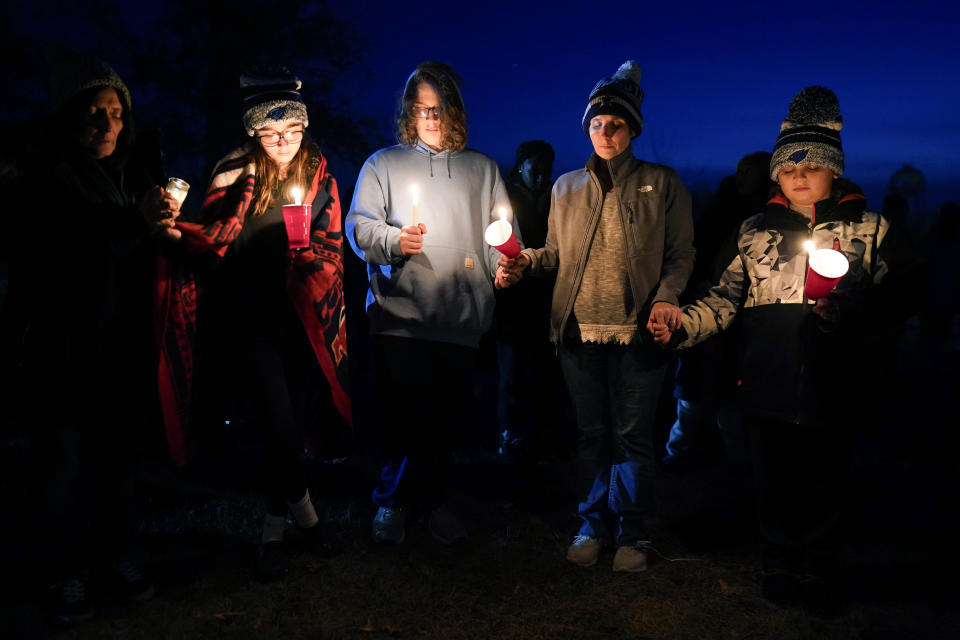 Local residents pray during a candlelight vigil following a shooting at Perry High School, Thursday, Jan. 4, 2024, in Perry, Iowa. (AP Photo/Charlie Neibergall)