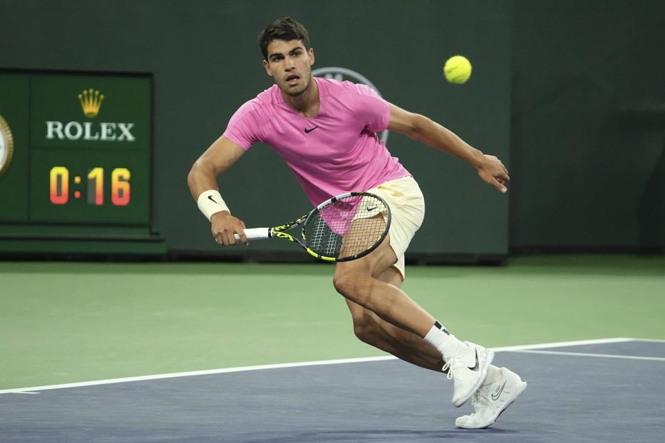 Carlos Alcaraz, of Spain, returns a shot to Tallon Griekspoor, of the Netherlands, at the BNP Paribas Open tennis tournament Monday, March 13, 2023, in Indian Wells, Calif. (AP Photo/Mark J. Terrill)